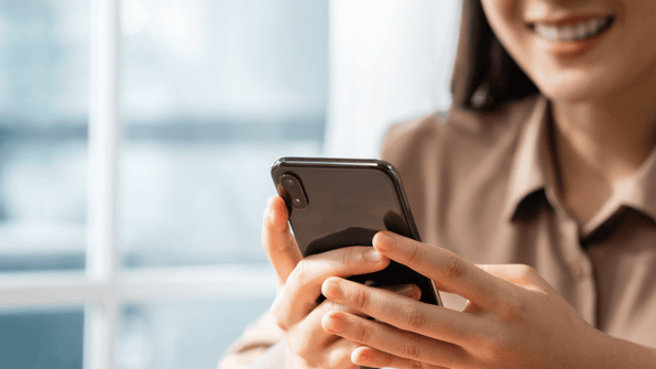 sharing on social media - woman with phone