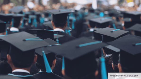 MBA graduates at graduation with blue hats