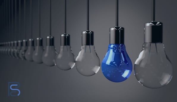 row of clear light bulbs with one blue one