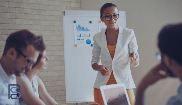 professor with charts behind her