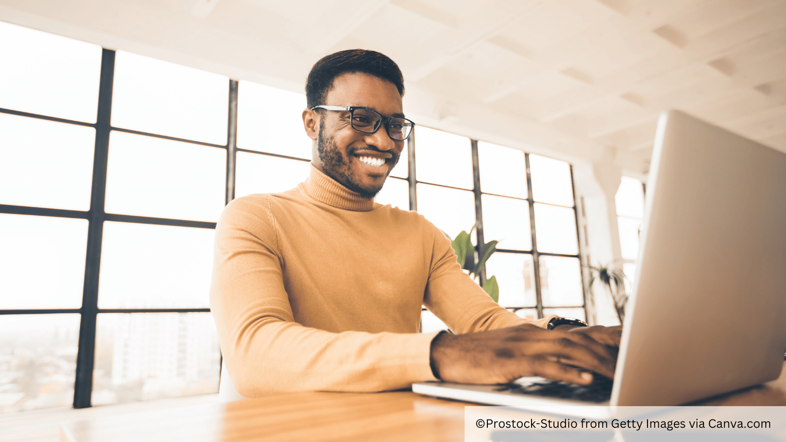 Building your presence online - man smiles at laptop