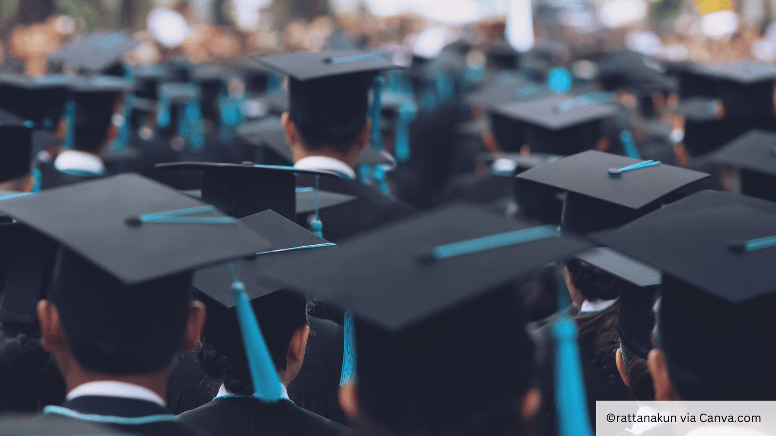 MBA graduates at graduation with blue hats