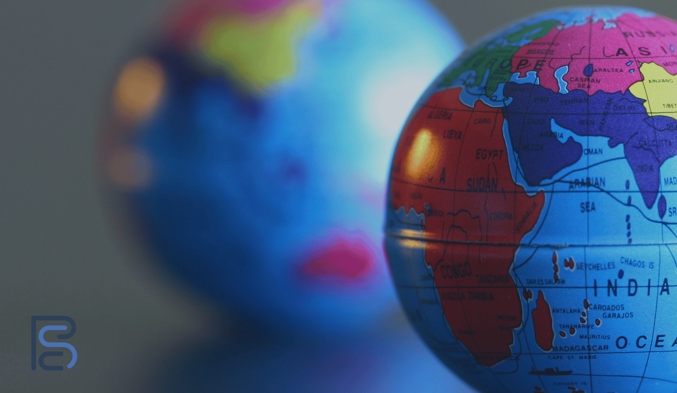 two globes with bright coloured countries