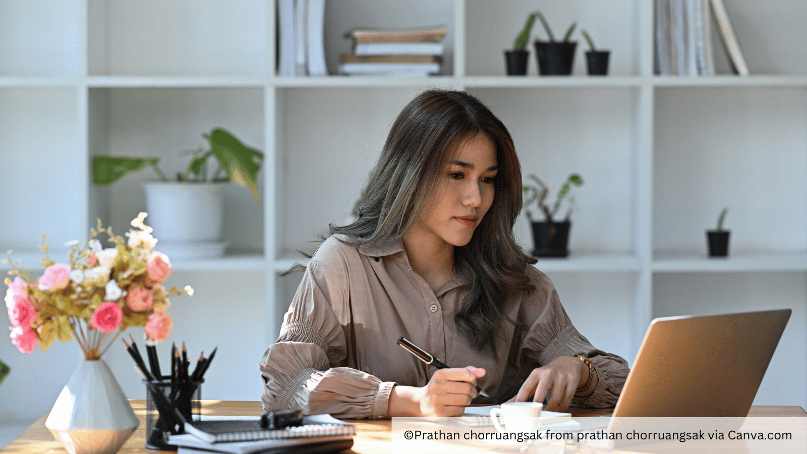 woman at desk reading LinkedIn newsletter