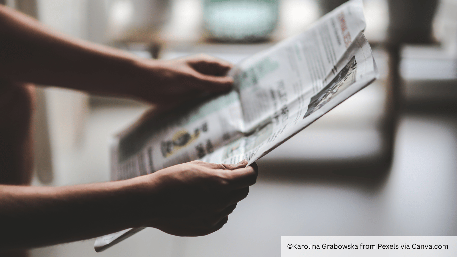 holding a newspaper