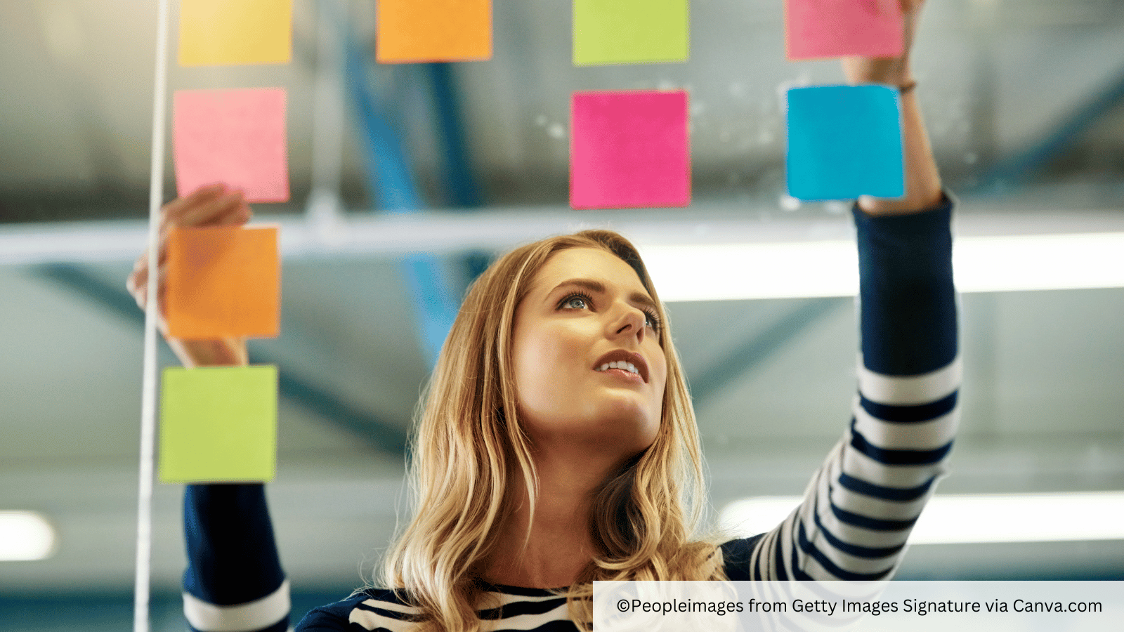woman reorganising post it notes